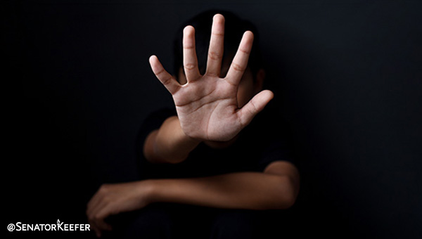 Black background with a hand palm open and fingers spread apart.