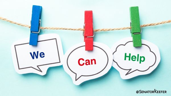 Clothesline with blue, red and green clothespins on it each holding a picture with a single word that spells out “we can help”.