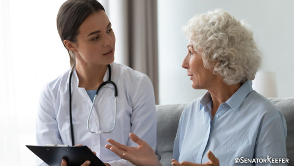 A doctor and patient sitting down talking.