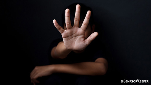 Black background with hand in a stop position.