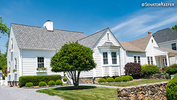 White house with landscaped yard.