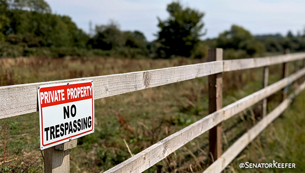 Fence with no trespassing sign on it.