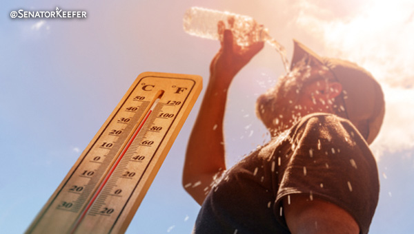 A thermometer on a sunny day with a man pouring water over his head.