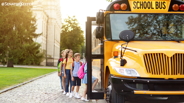 students getting on bus.