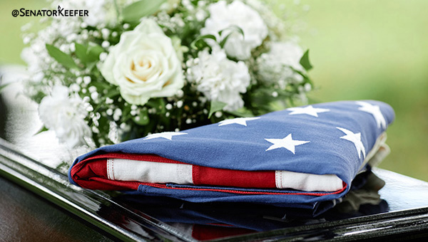 flag folded on top of a casket.