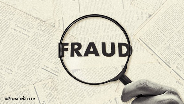 Magnifying glass with the word “Fraud”.